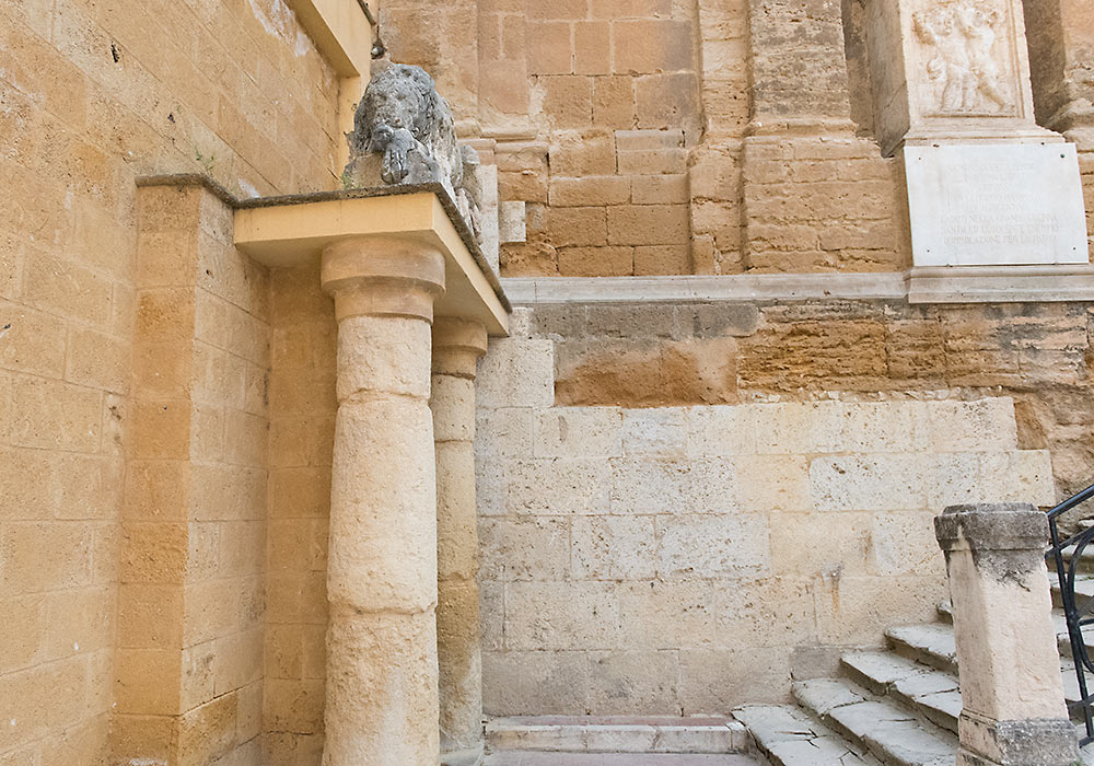The lion to the left of the church of the Purgatorio sleeps above the locked entrance to a huge labyrinth of underground water-channels and reservoirs, built by the Greek architect Phaiax in the 5th century BC