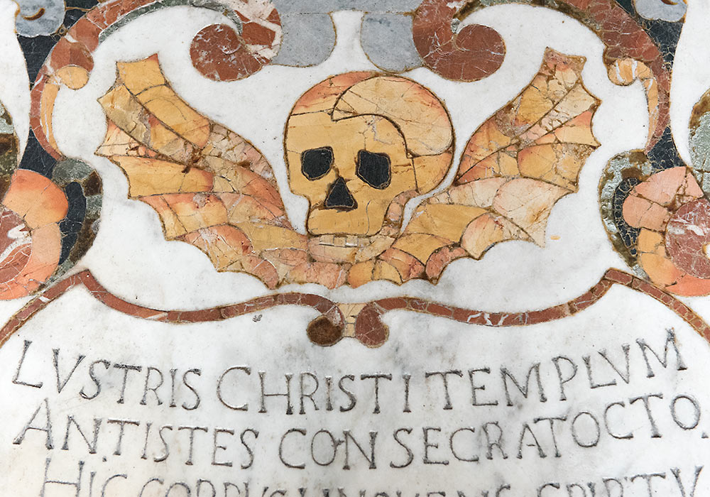 Skull on a marble tomb (anno 1697) in the Church of San Pancrazio, Taormina, Sicily