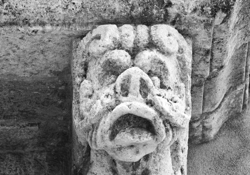 Acireale - grotesque head under balcony