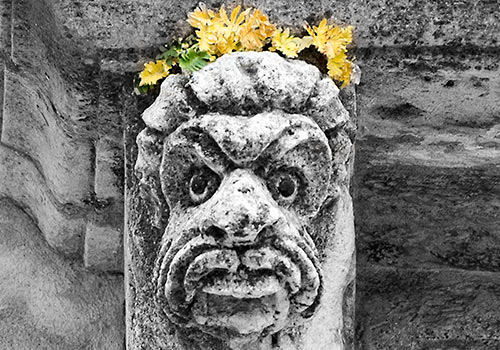 Acireale - grotesque head under balcony