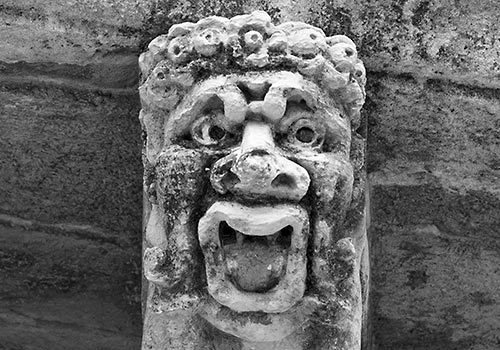 Acireale - grotesque head under balcony