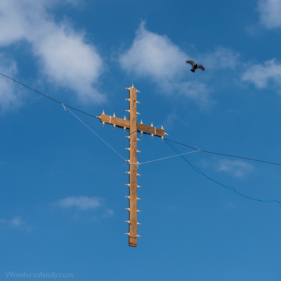 Cross and dove above a street in Palermo